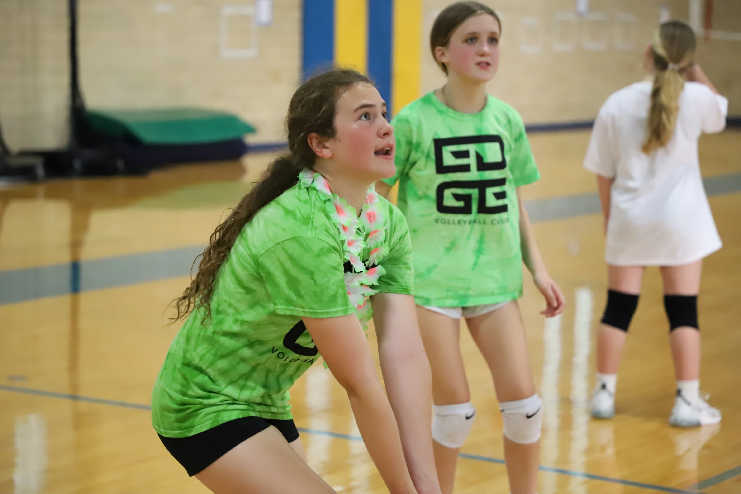 An Edge athlete playing volleyball while wearing all green in support for mental health awareness