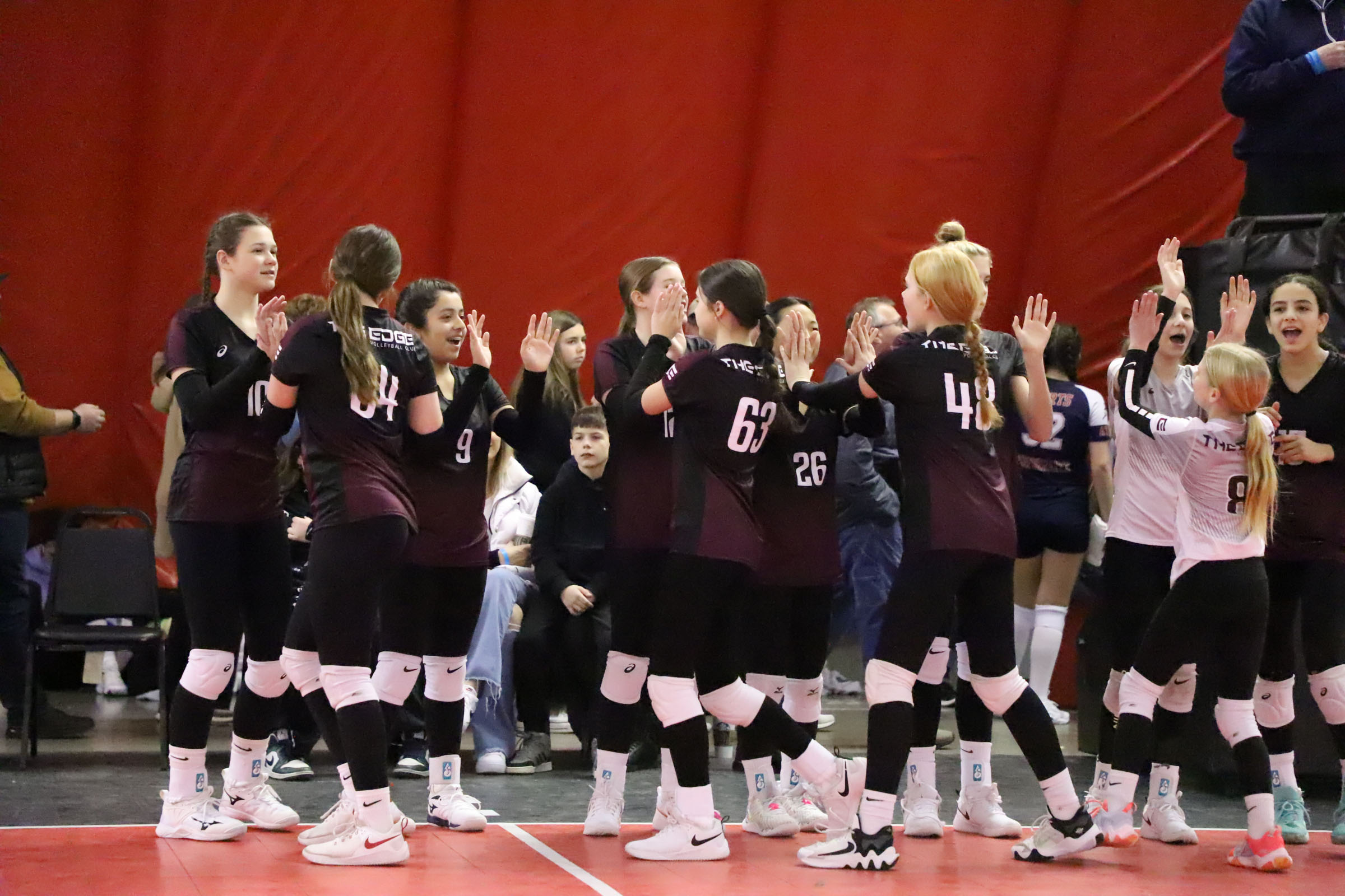 Group of Edge Volleyball athletes cheering each other on.