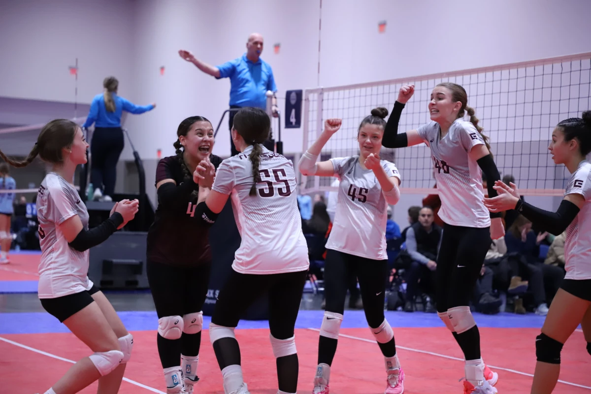 Edge athletes jumping in excitement as a team after a great volleyball play