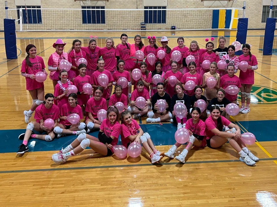 A group of Edge Volleyball athletes all wearing pink in a group photo