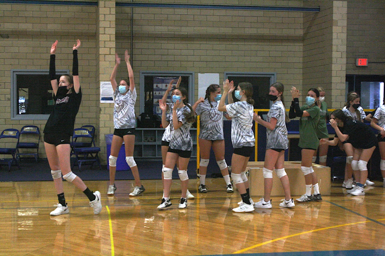 A group of Edge athletes throwing their hands in the air with excitement