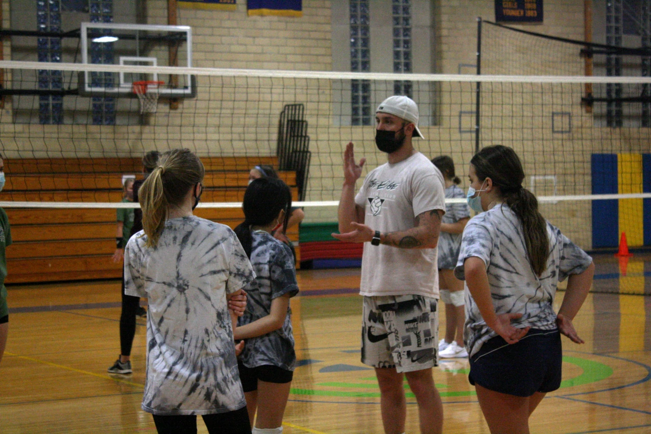 An Edge coach instructing athletes on their next drill